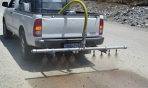 Bakkie-mounted spray bar dust suppression
