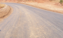 Curved gravel road dust suppression treatment