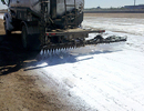 Spray bar applying dust suppressant