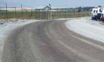 Unpaved terminal road with dust suppression treatment